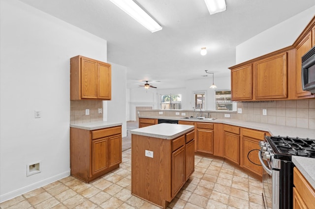 kitchen with pendant lighting, a center island, stainless steel stove, ceiling fan, and tasteful backsplash