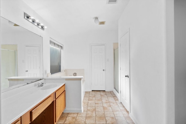 bathroom with vanity and an enclosed shower