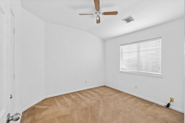 empty room featuring ceiling fan, light colored carpet, and lofted ceiling