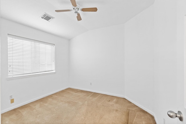 carpeted spare room with ceiling fan and lofted ceiling