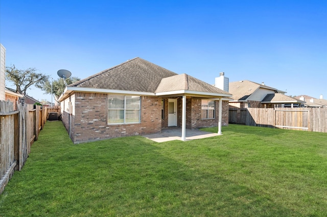 back of property with a patio and a lawn