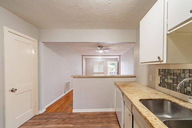 kitchen featuring white cabinets, ceiling fan, dark wood-type flooring, sink, and dishwasher