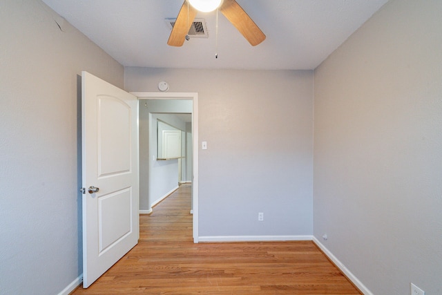 empty room featuring light hardwood / wood-style flooring and ceiling fan