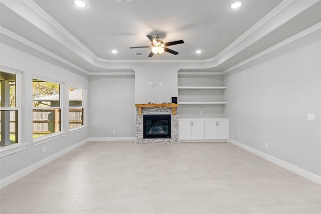 unfurnished living room with ornamental molding, built in shelves, ceiling fan, light tile patterned floors, and a fireplace