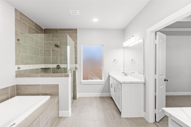 bathroom featuring vanity and independent shower and bath