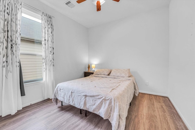 bedroom with hardwood / wood-style flooring and ceiling fan