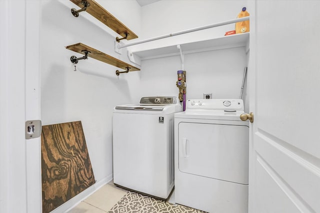 laundry area featuring separate washer and dryer and light tile patterned floors