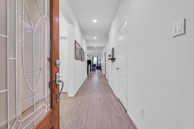 corridor with light wood-type flooring