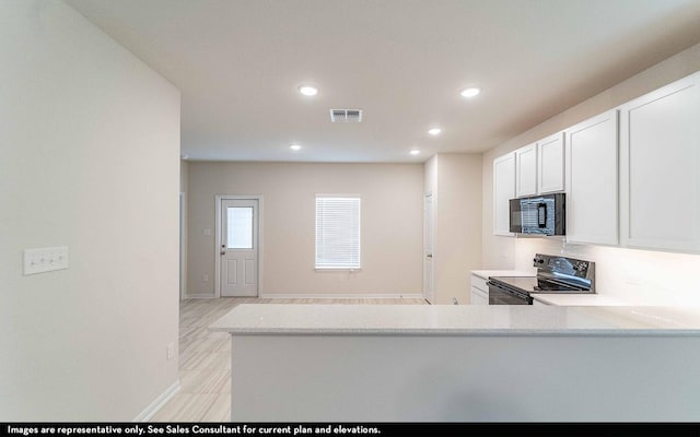 kitchen with white cabinets, kitchen peninsula, and black appliances