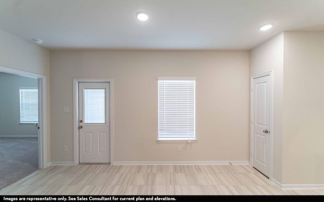 entrance foyer with light colored carpet