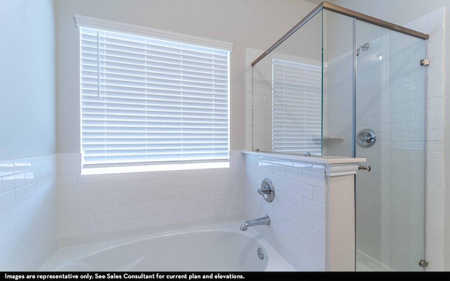 bathroom featuring separate shower and tub