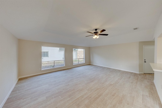 spare room featuring light hardwood / wood-style floors and ceiling fan