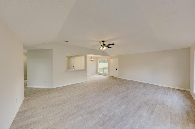 unfurnished room with ceiling fan, light wood-type flooring, and vaulted ceiling