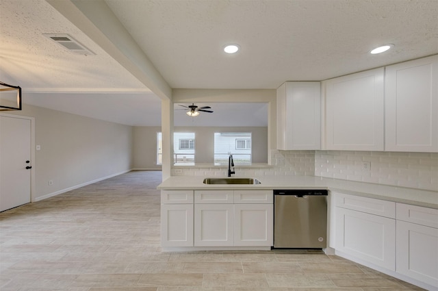 kitchen featuring backsplash, white cabinets, ceiling fan, sink, and dishwasher