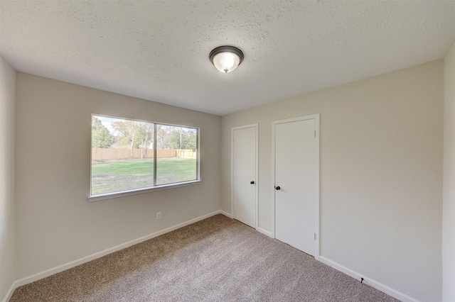 unfurnished bedroom with carpet floors and a textured ceiling