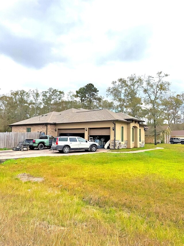 view of home's exterior featuring a garage and a lawn