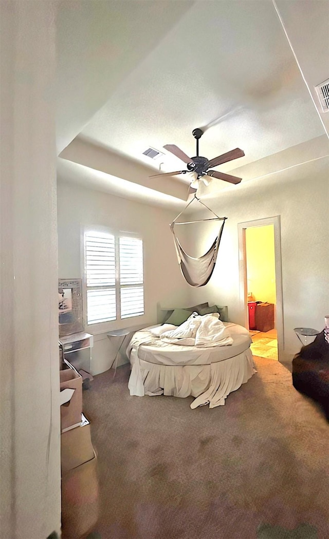 bedroom featuring ceiling fan, carpet floors, and ensuite bath