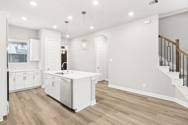 kitchen with white cabinets, sink, white dishwasher, and pendant lighting