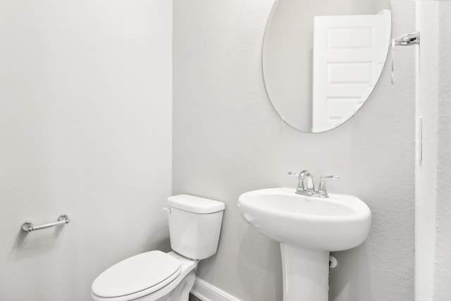 bathroom with toilet and sink