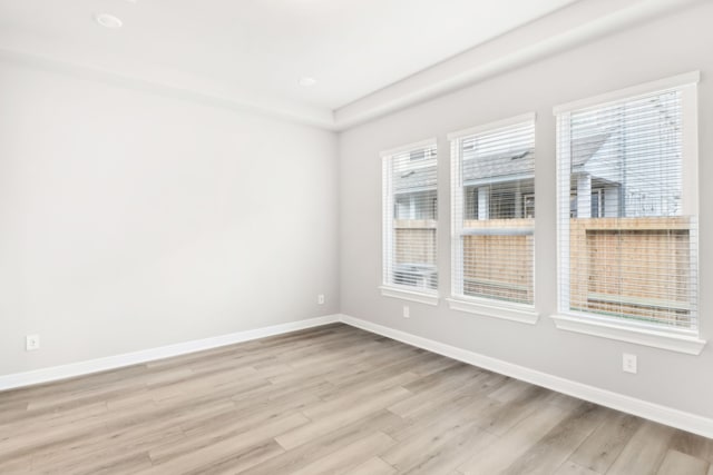 spare room featuring light hardwood / wood-style flooring