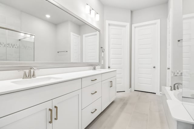 bathroom with plus walk in shower, vanity, and tile patterned flooring