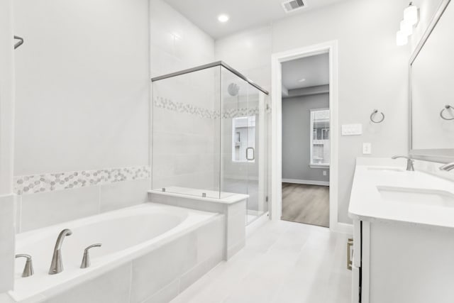 bathroom with separate shower and tub, tile patterned floors, and vanity