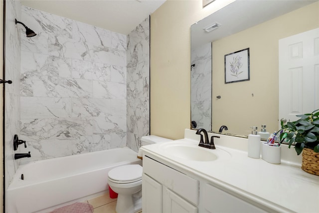 full bathroom featuring tile patterned flooring, vanity, toilet, and tiled shower / bath