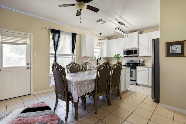 dining area featuring ceiling fan and light tile patterned flooring