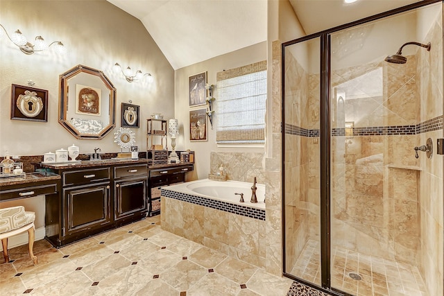 bathroom featuring a garden tub, a shower stall, vaulted ceiling, and vanity