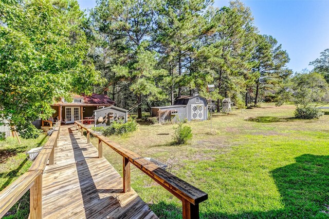 view of yard featuring french doors and a storage shed