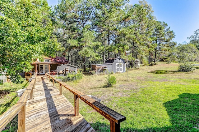 view of yard featuring a storage shed, an outbuilding, and french doors