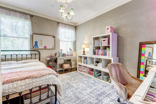 bedroom featuring a chandelier and wood-type flooring