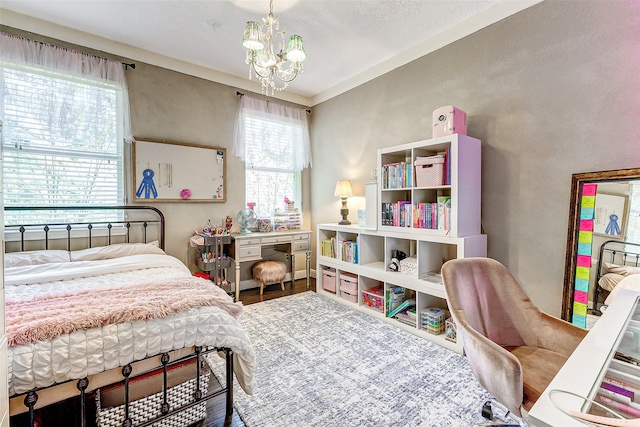 bedroom with a chandelier and wood finished floors