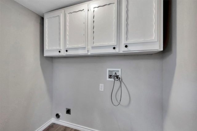 washroom featuring electric dryer hookup, cabinets, wood-type flooring, and hookup for a washing machine