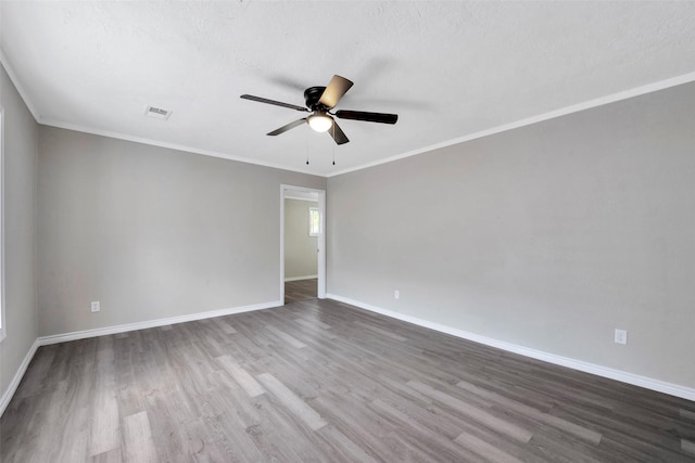 unfurnished room featuring hardwood / wood-style floors, a textured ceiling, ceiling fan, and crown molding