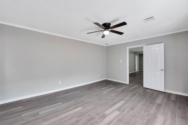 unfurnished room with hardwood / wood-style floors, ceiling fan, and crown molding