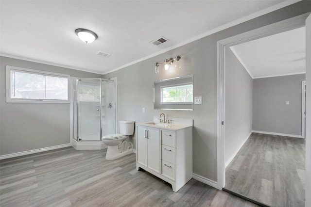 bathroom featuring vanity, hardwood / wood-style flooring, toilet, and a healthy amount of sunlight