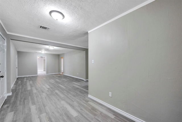 unfurnished room with a textured ceiling and light hardwood / wood-style flooring