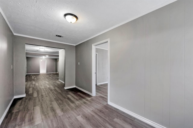 empty room with crown molding and dark wood-type flooring