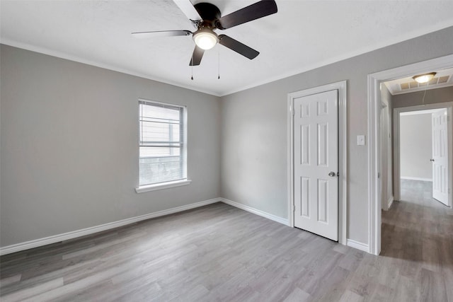 unfurnished bedroom featuring ceiling fan, ornamental molding, and light hardwood / wood-style flooring