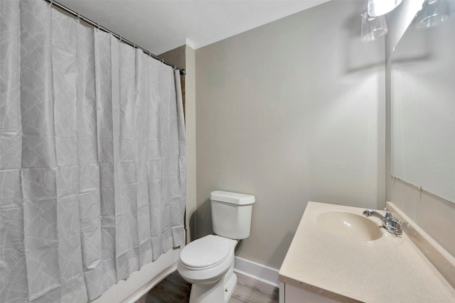 full bathroom with vanity, wood-type flooring, shower / tub combo, and toilet