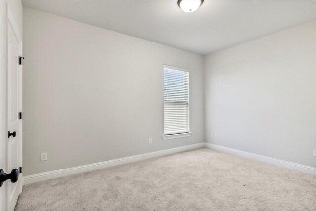 empty room featuring light carpet