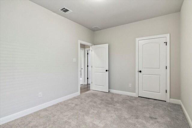 unfurnished bedroom with light carpet