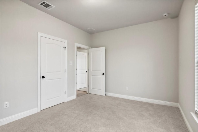 unfurnished bedroom featuring light colored carpet