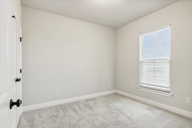 unfurnished room with light carpet