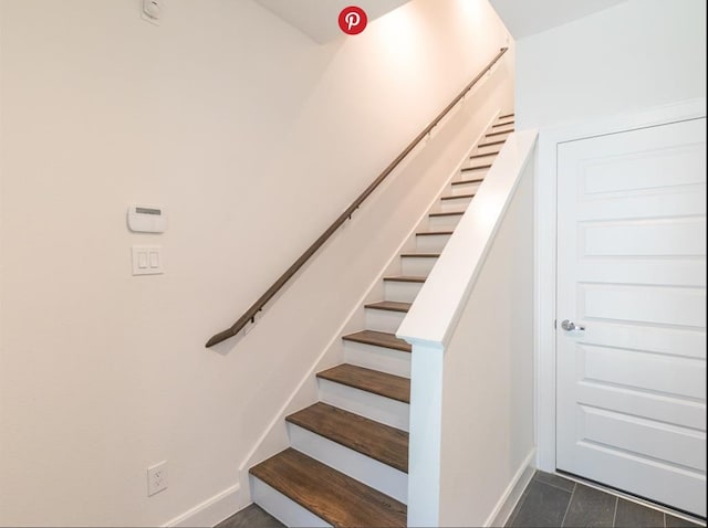 stairway featuring tile patterned flooring