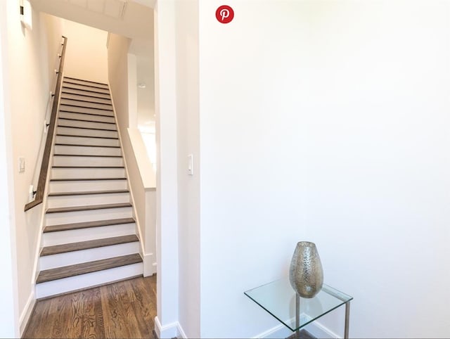 stairs featuring hardwood / wood-style floors