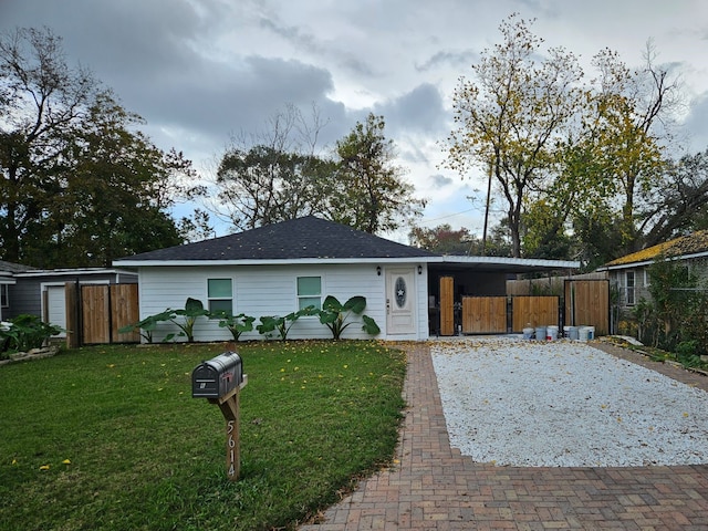 ranch-style home with a front yard and a carport