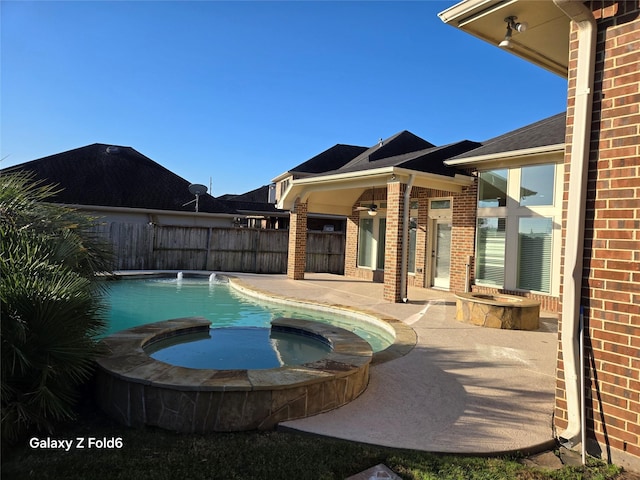 view of pool featuring pool water feature, ceiling fan, an in ground hot tub, and a patio