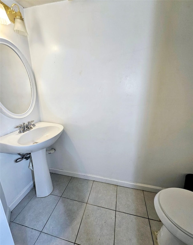 bathroom featuring tile patterned floors, toilet, and sink